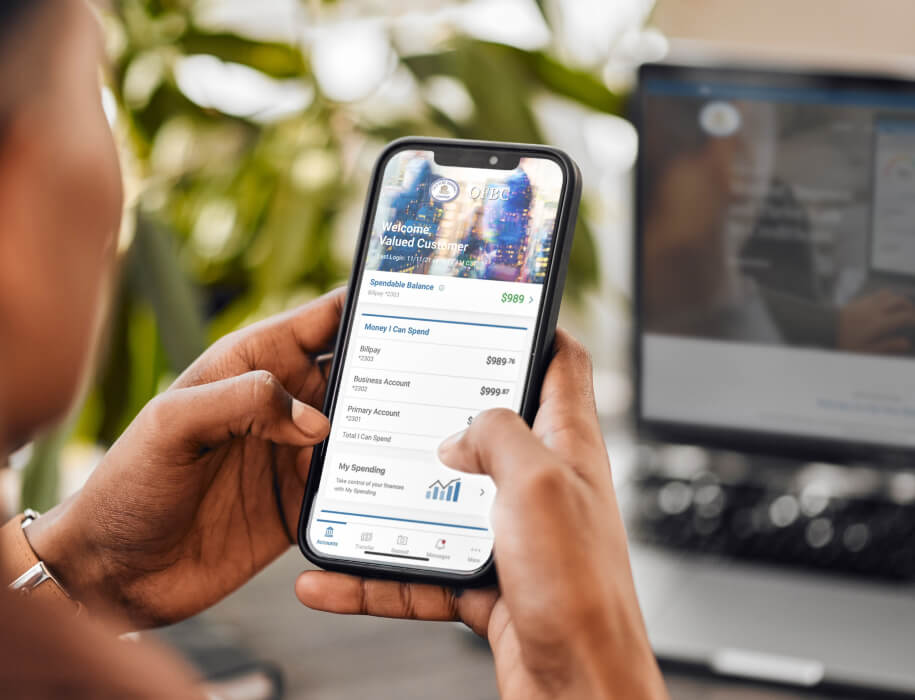 Person holding phone with mobile banking app